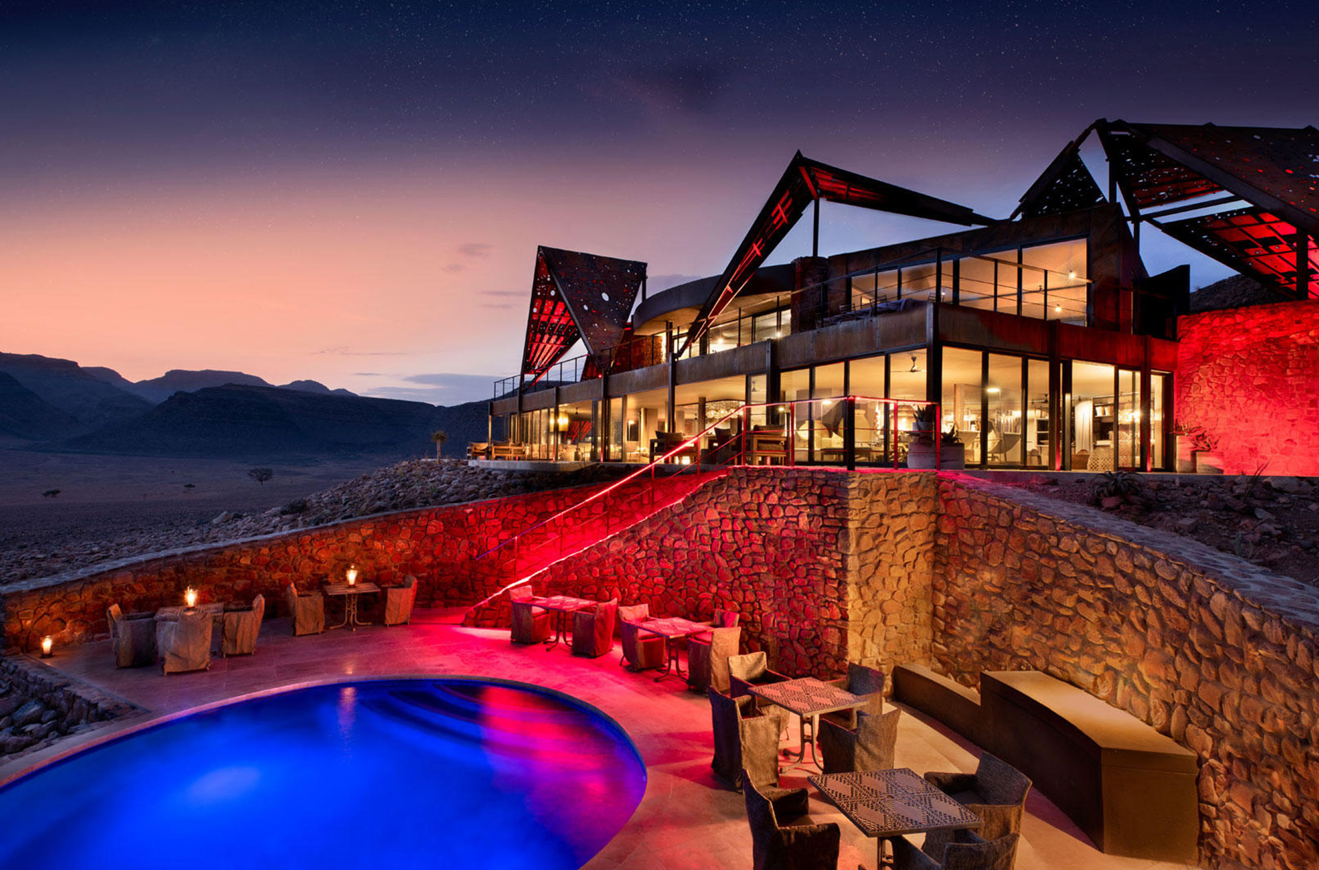 Exterior by night with pool - Sossusvlei Desert Lodge &Beyond Namibia - Luxury Africa Safaris